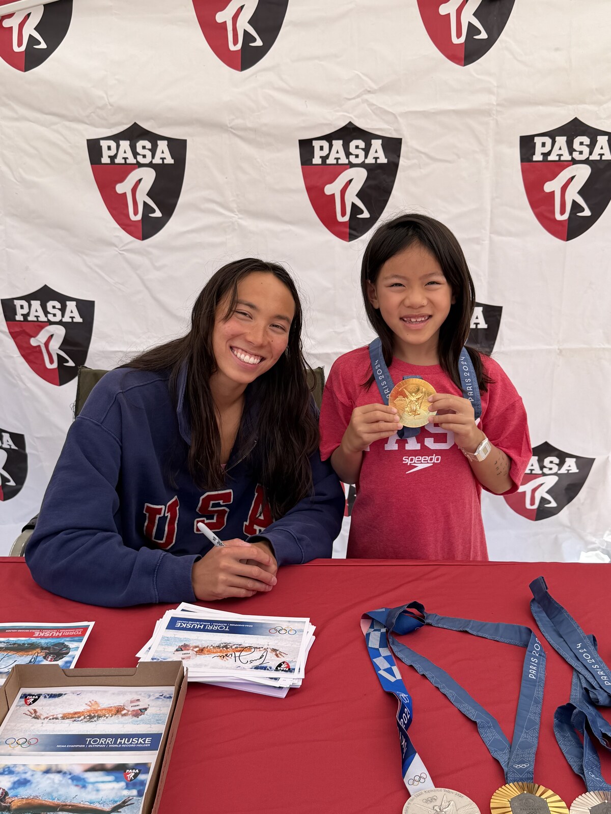 Olympic champion Torri Huske with PASA swimmers at PASA-Rinconada, signing autographs and posing with her Paris 2024 Olympic gold medal
