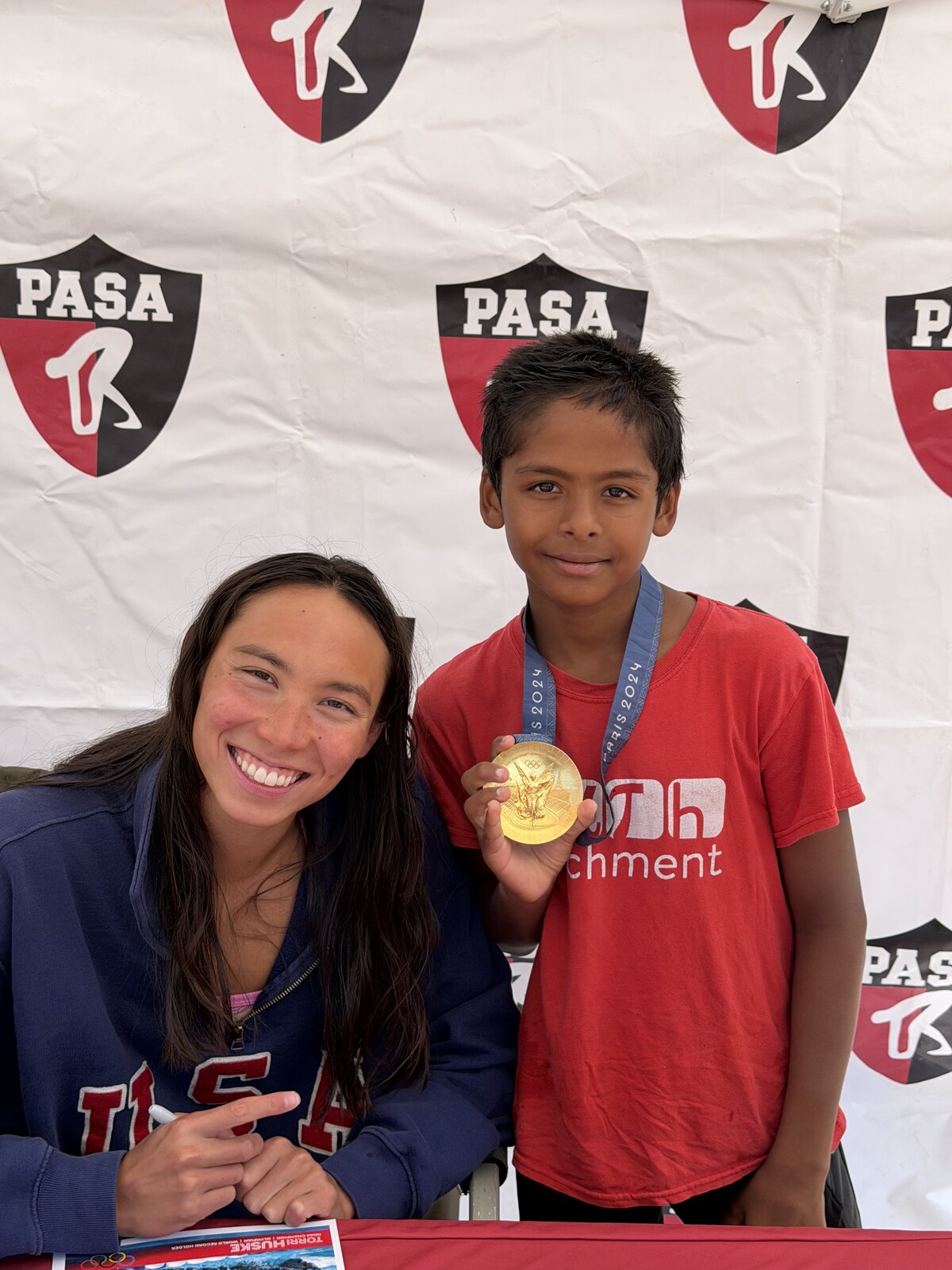 Olympic champion Torri Huske with PASA swimmers at PASA-Rinconada, signing autographs and posing with her Paris 2024 Olympic gold medal